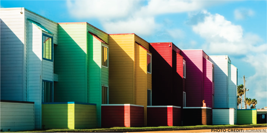 A row of terraced houses in rainbow colours. Photo credit Adrian N.